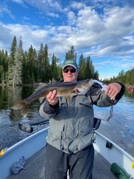 fish1 Man holding a fish freshly caught at Woman Lake Lodge Canada