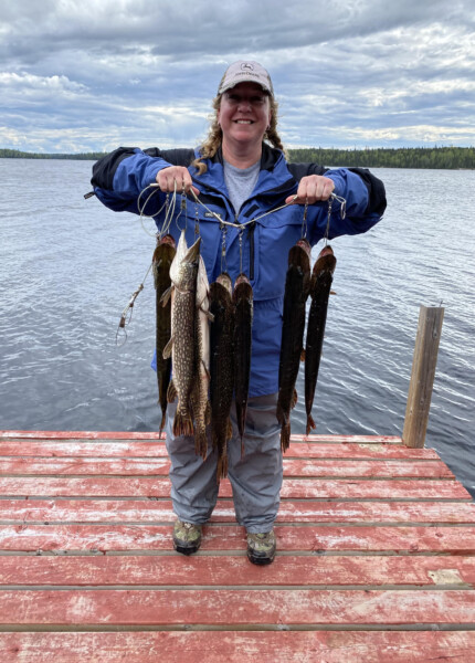 fish10 Woman holding a string of fish freshly caught at Woman Lake Lodge Canada