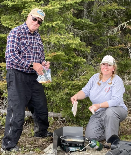fish18 A couple grilling up a lake lunch at woman lake lodge canada
