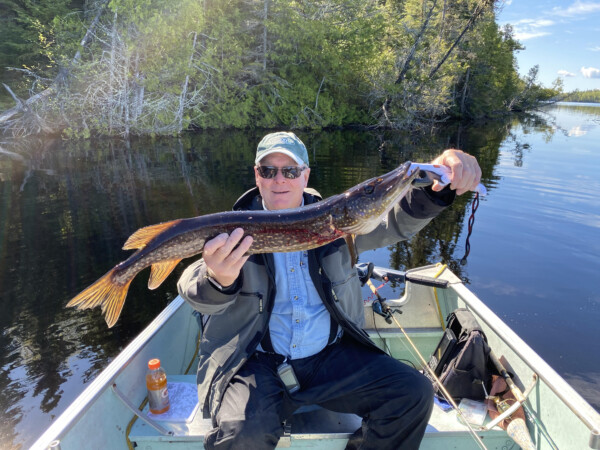 fish21 Man holding a fish freshly caught at Woman Lake Lodge Canada