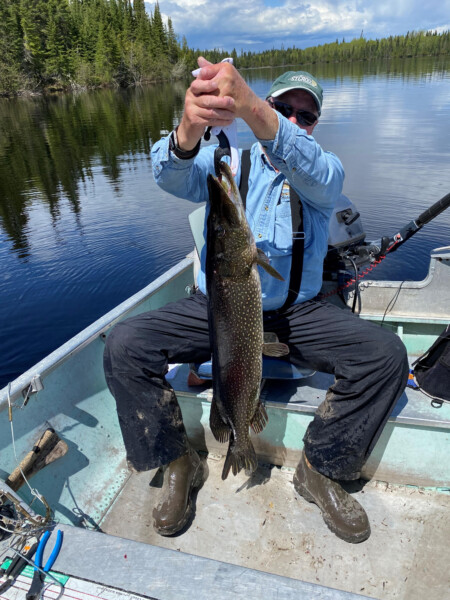 fish22 Man holding a fish freshly caught at Woman Lake Lodge Canada