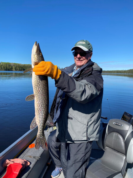 fish5 Man holding a fish freshly caught fish at Woman Lake Lodge Canada