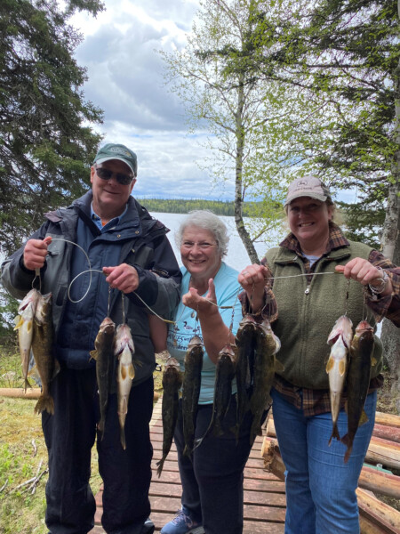 fish7 A family holding a freshly caught string of fish at Woman Lake Lodge