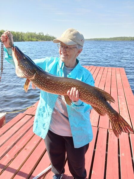 20230528_102425_600x Person holding a freshly caught fish at Woman Lake Lodge
