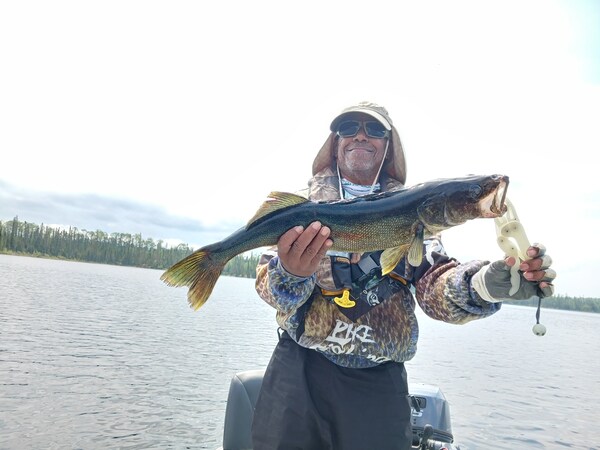20230601_112428_600x Man holding a freshly caught fish at Woman Lake Lodge