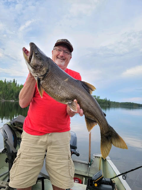 fishing28 Man holding a freshly caught fish at Woman Lake Lodge