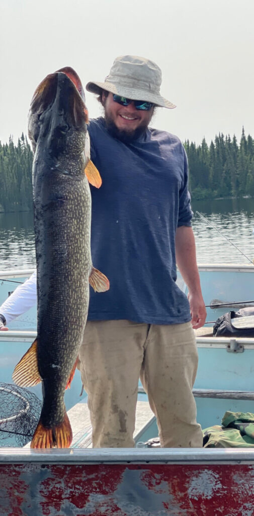 fishing30 Man holding a massive pike fish at Woman Lake Lodge in Ontario Canada