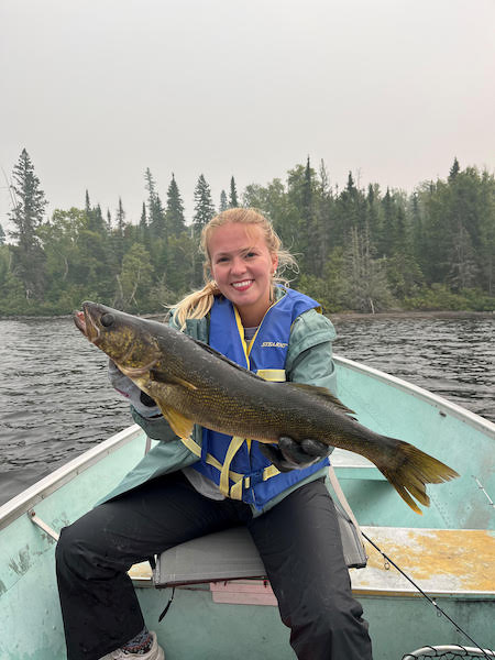 fishing-36 A lady holding a freshly caught fish at Woman Lake Lodge