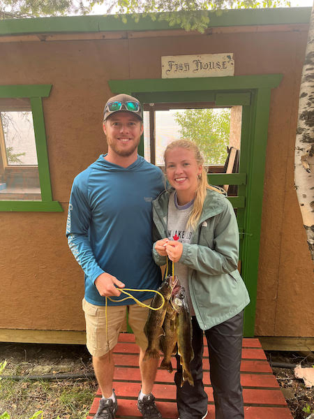 fishing-37 A couple holding a line of fish caught at Woman Lake Lodge