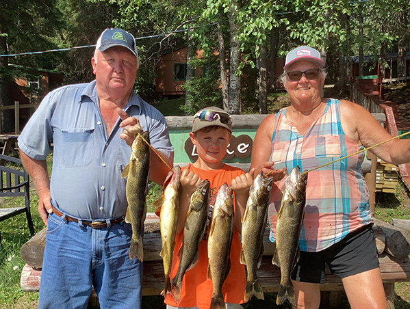 fishing33-web Family holding a string of freshly caught fish at Woman Lake Lodge