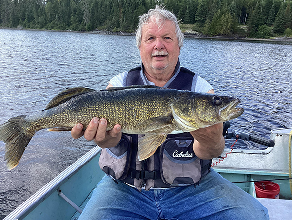 fishing34-web Greg Erickson holding a freshly caught fish at Woman Lake Lodge