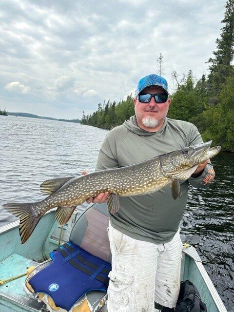 matt Matt catching a large fish at Woman Lake Lodge